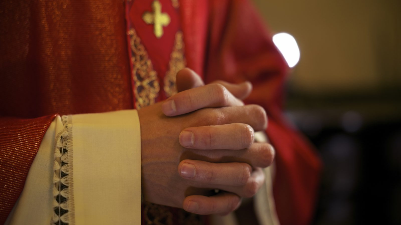 Priester handen gevouwen
